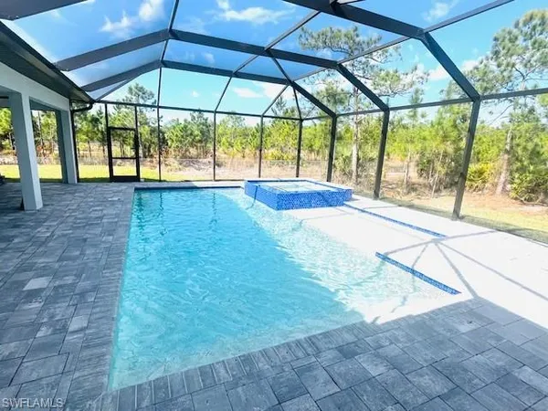 a view of empty room with wooden floor and umbrella