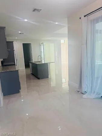 a view of wooden floor and windows in a room