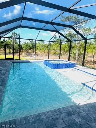 a view of yard with a table and chairs under an umbrella