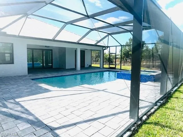 a kitchen with granite countertop white cabinets and a stove