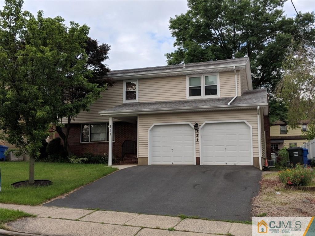 131 South Cliff Road Colonia, NJ 07067 - Photo 1 of 20 a front view of a house with a garage
