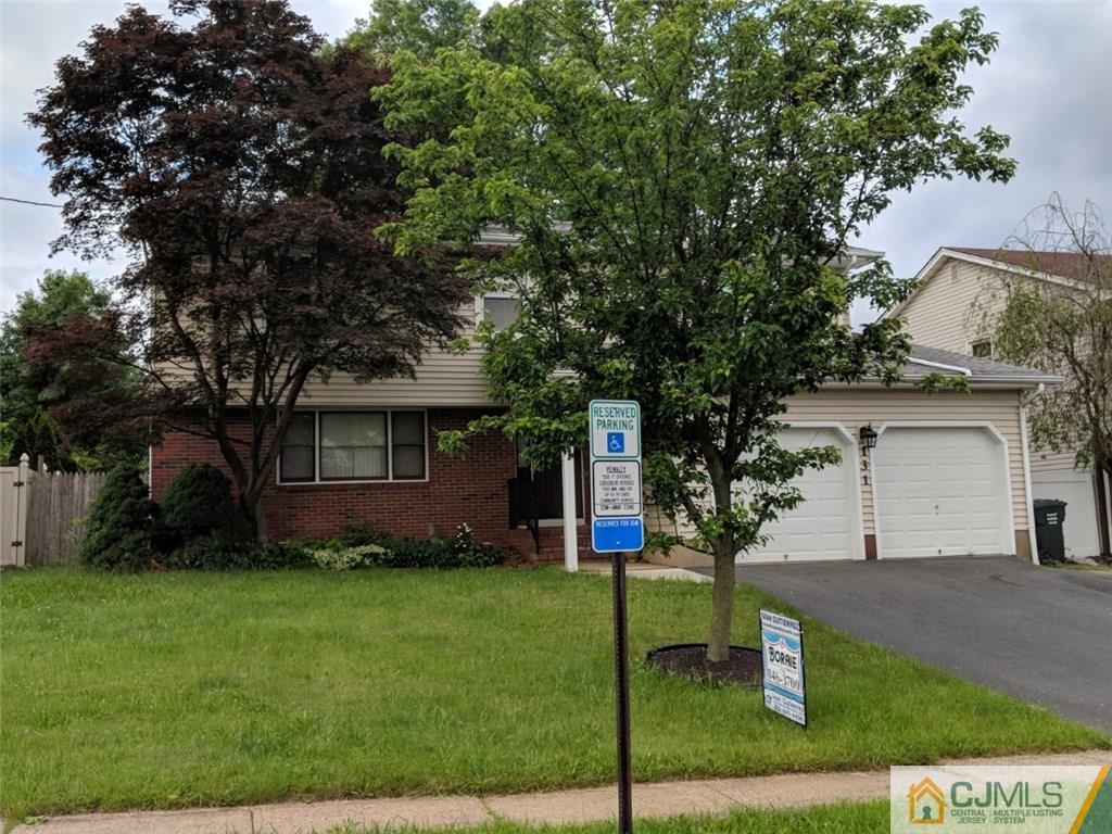 131 South Cliff Road Colonia, NJ 07067 - Photo 2 of 20 a front view of a house with a garden and trees