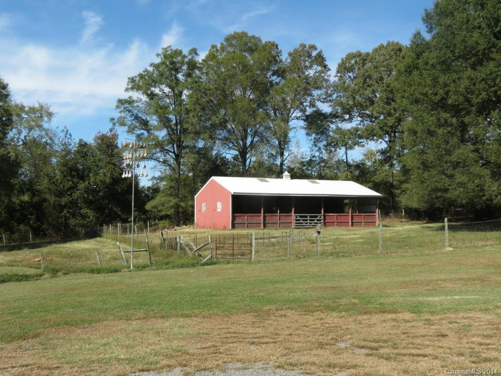 4655 Percival Road Rock Hill, SC 29730 - Photo 2 of 14 a white house with a yard and trees in the background