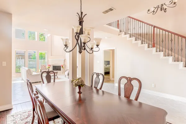 a dining room with furniture potted plants and wooden floor