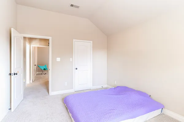 a bedroom with a bed and a mirror