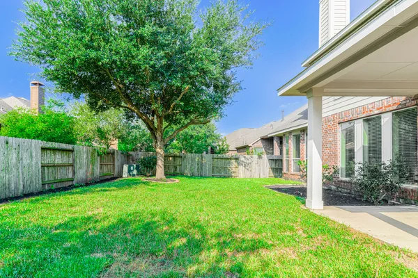a view of a house with a yard and sitting area