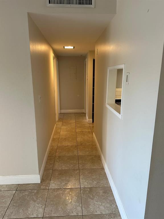 400 North Riverside Drive, Unit 102 102 Pompano Beach, FL 33062 - Photo 14 of 20 a view of hallway with a rug and a window