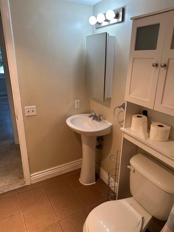 400 North Riverside Drive, Unit 102 102 Pompano Beach, FL 33062 - Photo 19 of 20 a bathroom with a toilet sink and mirror