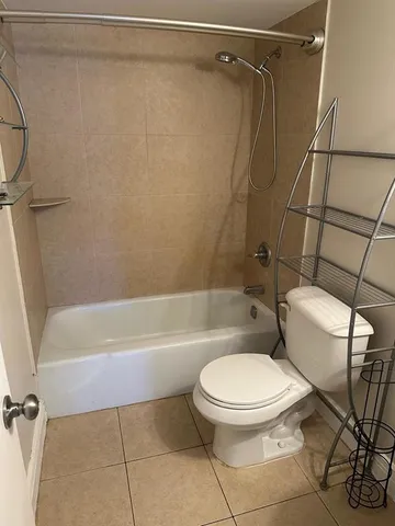 a white toilet and tub next to a bathroom sink