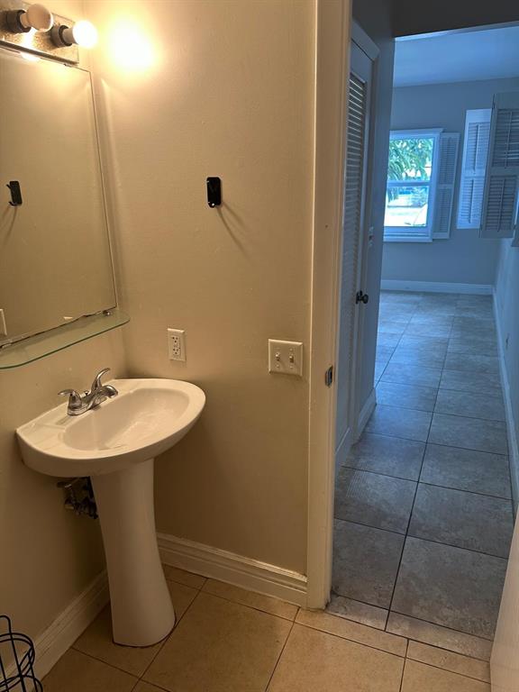 400 North Riverside Drive, Unit 102 102 Pompano Beach, FL 33062 - Photo 10 of 20 a bathroom with a sink a toilet and mirror