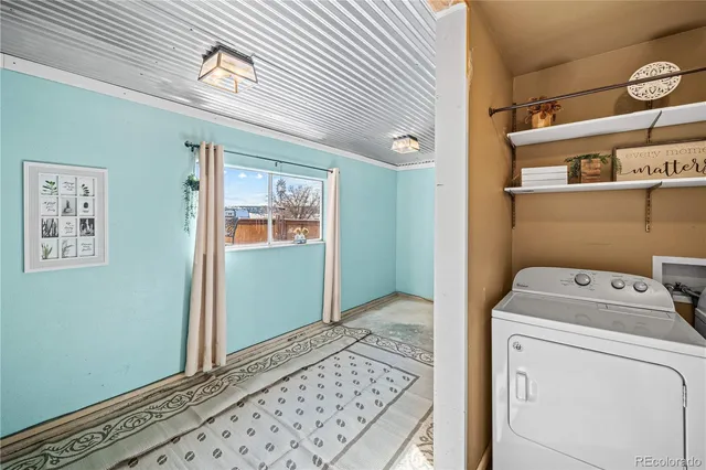a kitchen with stainless steel appliances granite countertop a stove and a view of living room