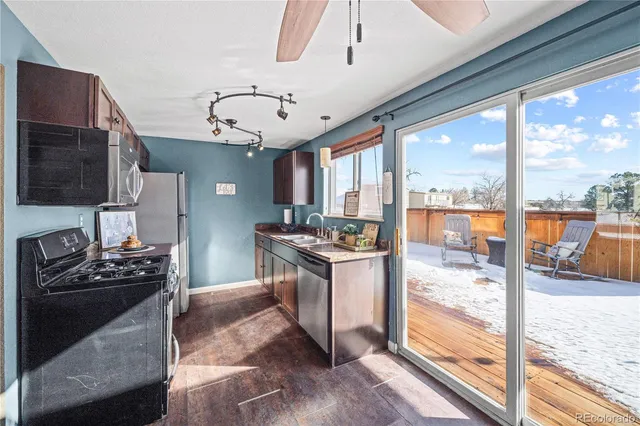 a kitchen with stainless steel appliances granite countertop a sink stove and cabinets