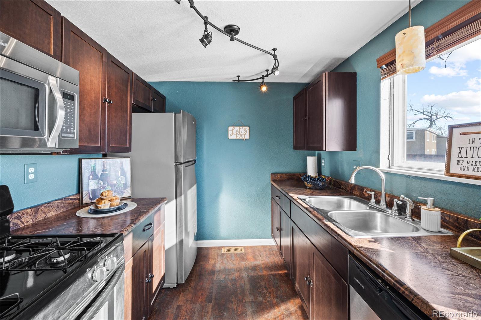 3126 County Rd CC254 Colorado City, CO 81019 - Photo 17 of 50 a kitchen with stainless steel appliances granite countertop a sink stove and refrigerator