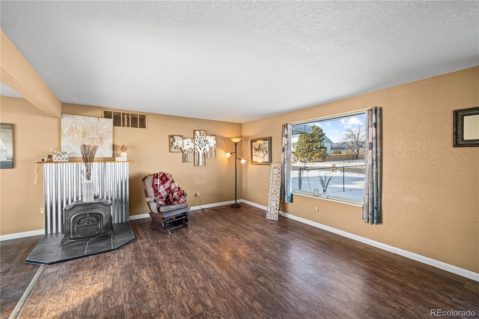 3126 County Rd CC254 Colorado City, CO 81019 - Photo 21 of 50 a living room with furniture a wooden floor and a large window