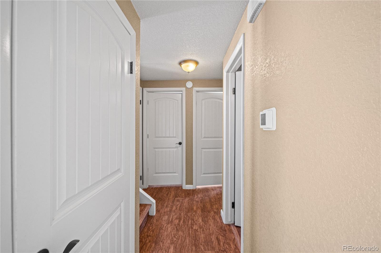 3126 County Rd CC254 Colorado City, CO 81019 - Photo 22 of 50 a view of a hallway with wooden floor and glass door