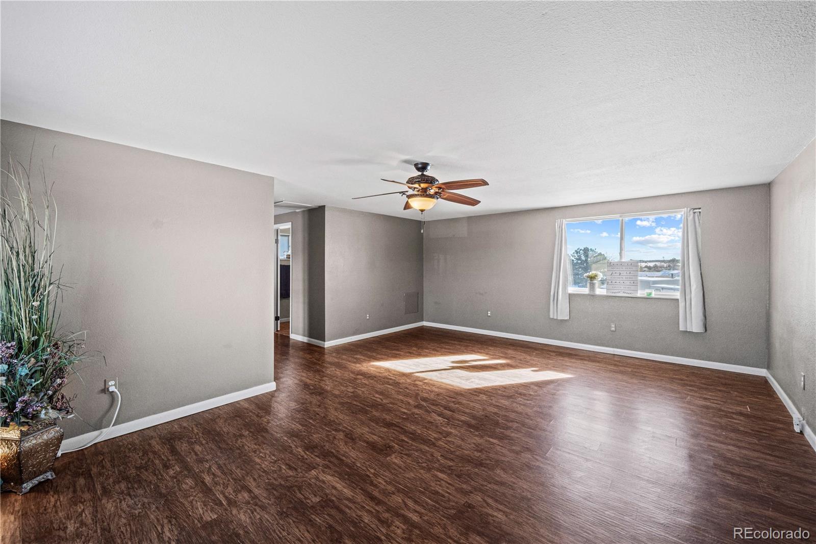 3126 County Rd CC254 Colorado City, CO 81019 - Photo 35 of 50 a view of empty room with wooden floor and fan