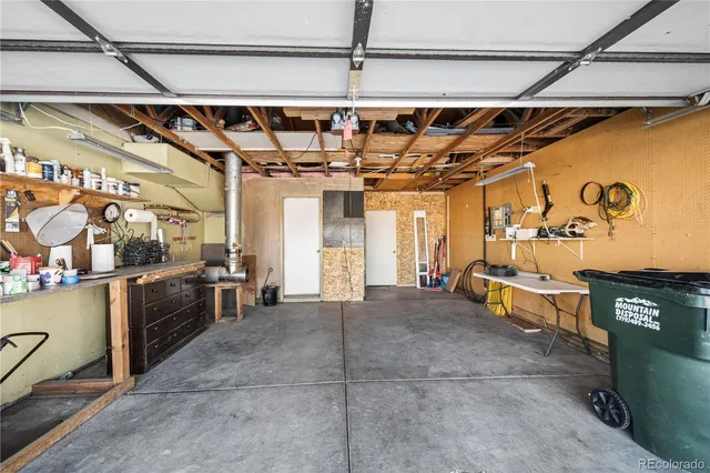 a view of a roof deck with table and chairs
