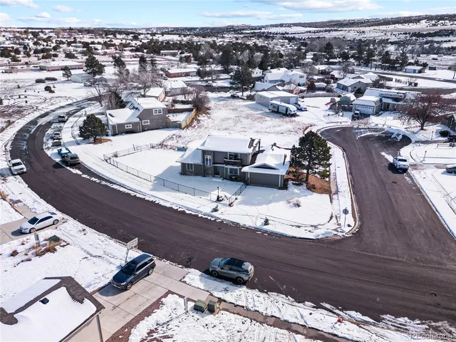an aerial view of a house with a swimming pool