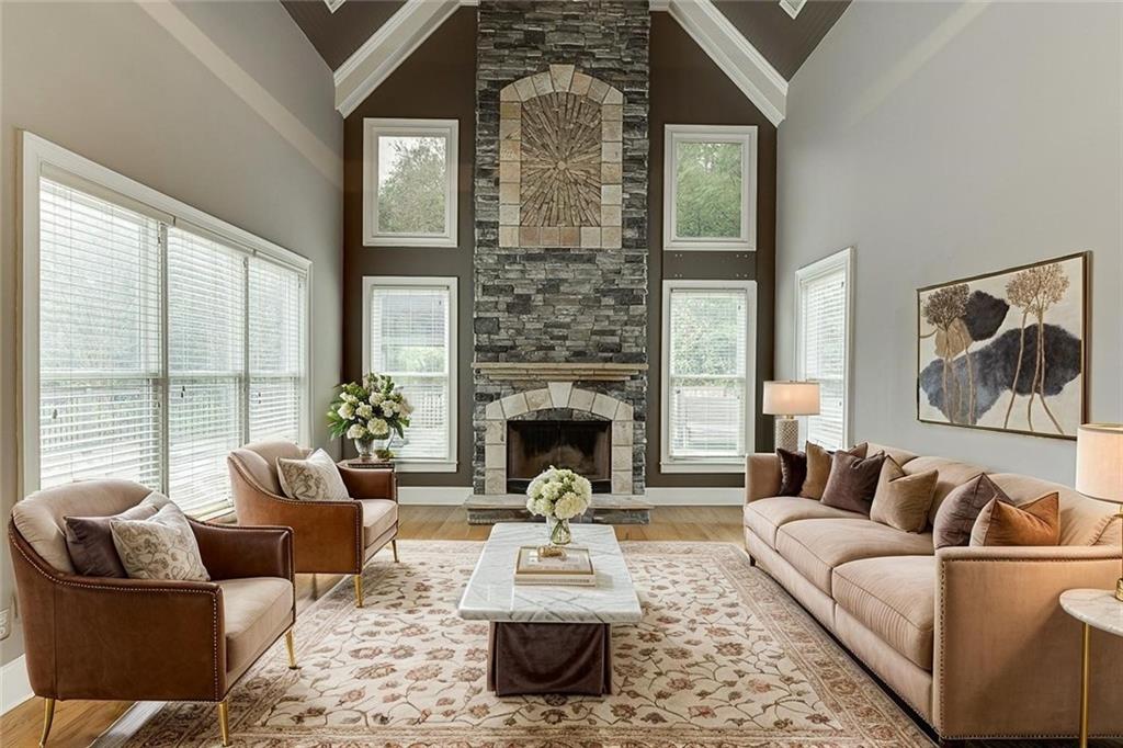 940 Chateau Forest Road Hoschton, GA 30548 - Photo 14 of 87 a living room with furniture fireplace and a large window