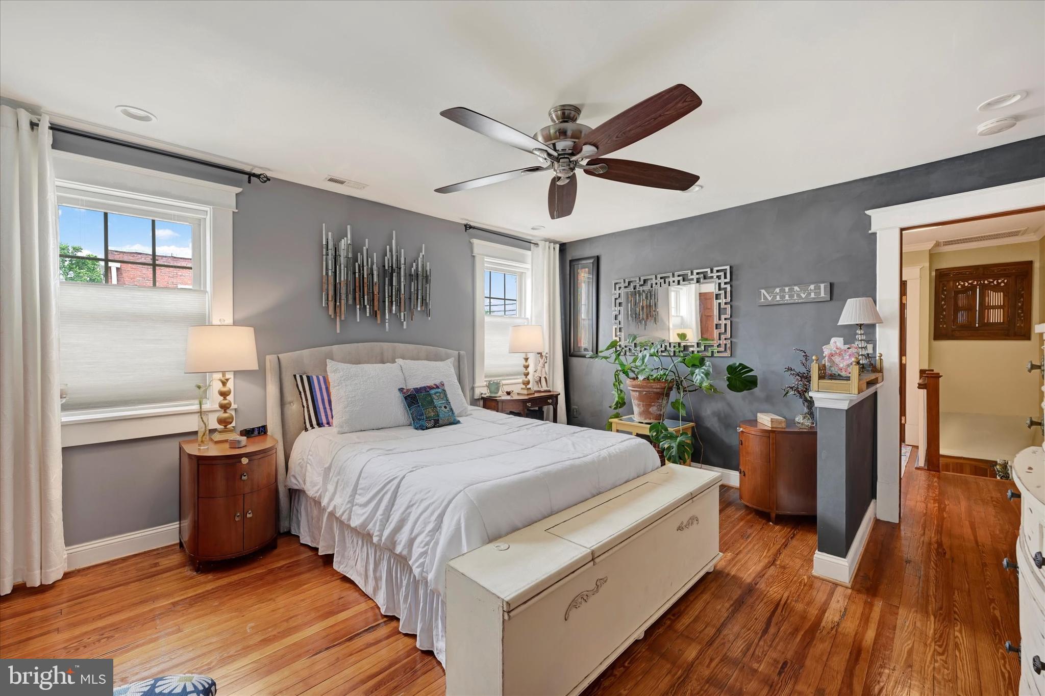 4224 Evans Chapel Road Baltimore, MD 21211 - Photo 12 of 24 a bedroom with a large bed and a chandelier