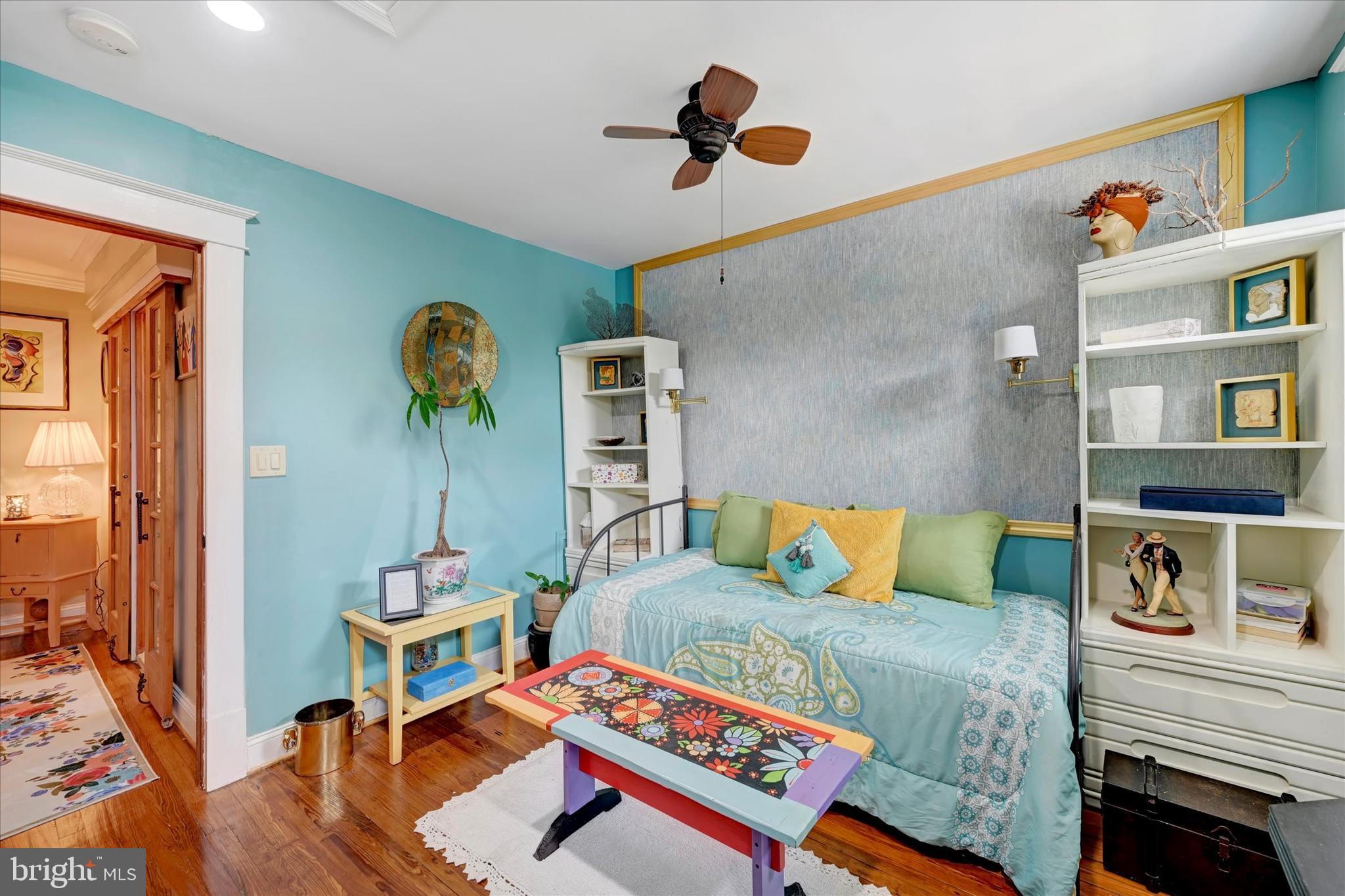 4224 Evans Chapel Road Baltimore, MD 21211 - Photo 15 of 24 a bedroom with a bed and a chandelier