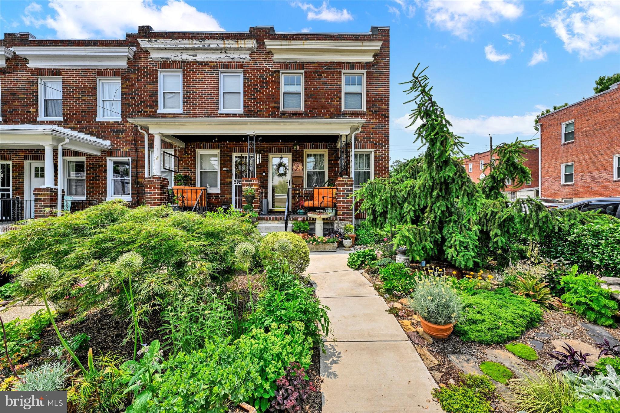 4224 Evans Chapel Road Baltimore, MD 21211 - Photo 2 of 24 front view of a brick house with a yard