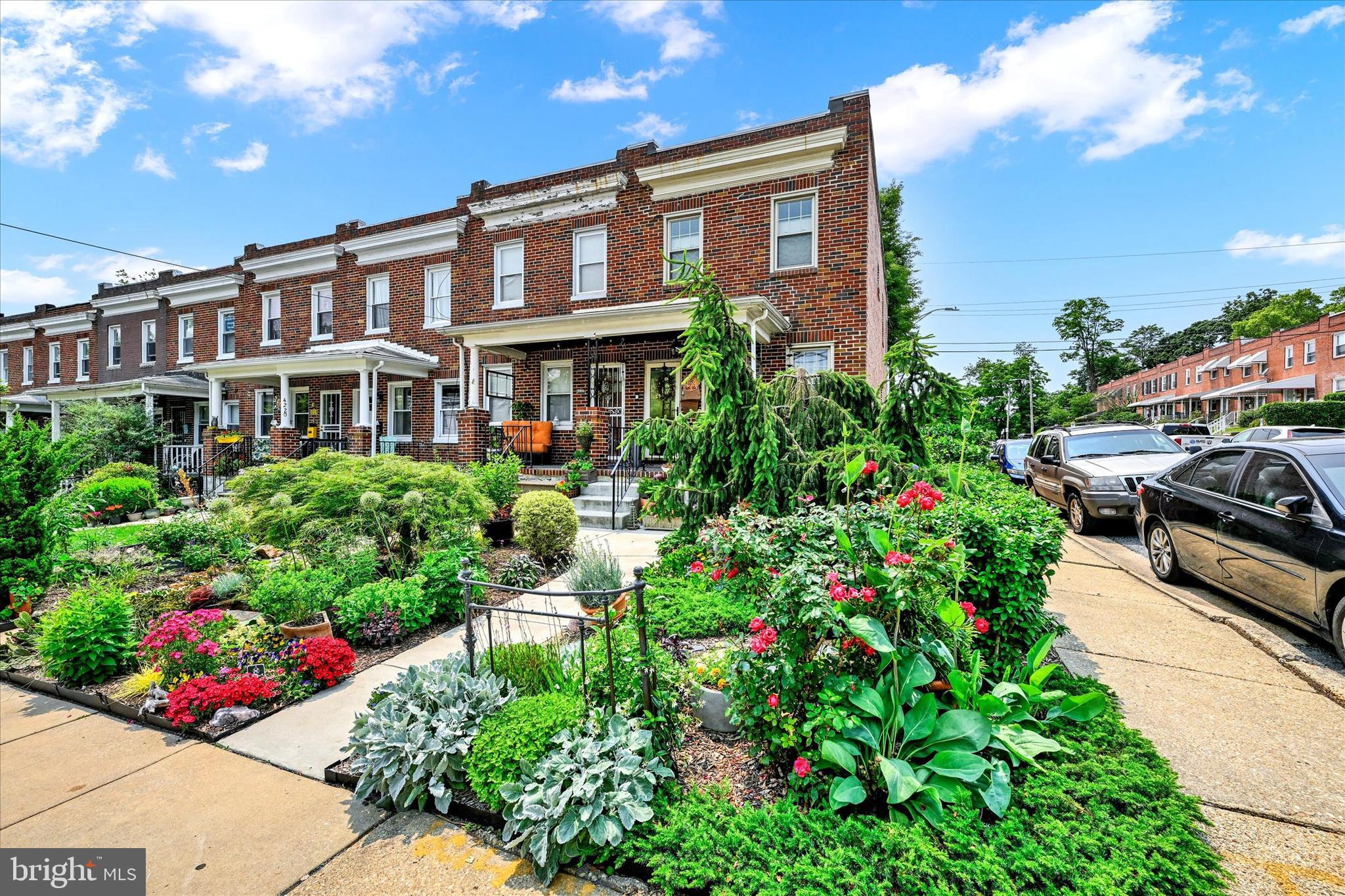 4224 Evans Chapel Road Baltimore, MD 21211 - Photo 3 of 24 a house with lots of flowers in front of it