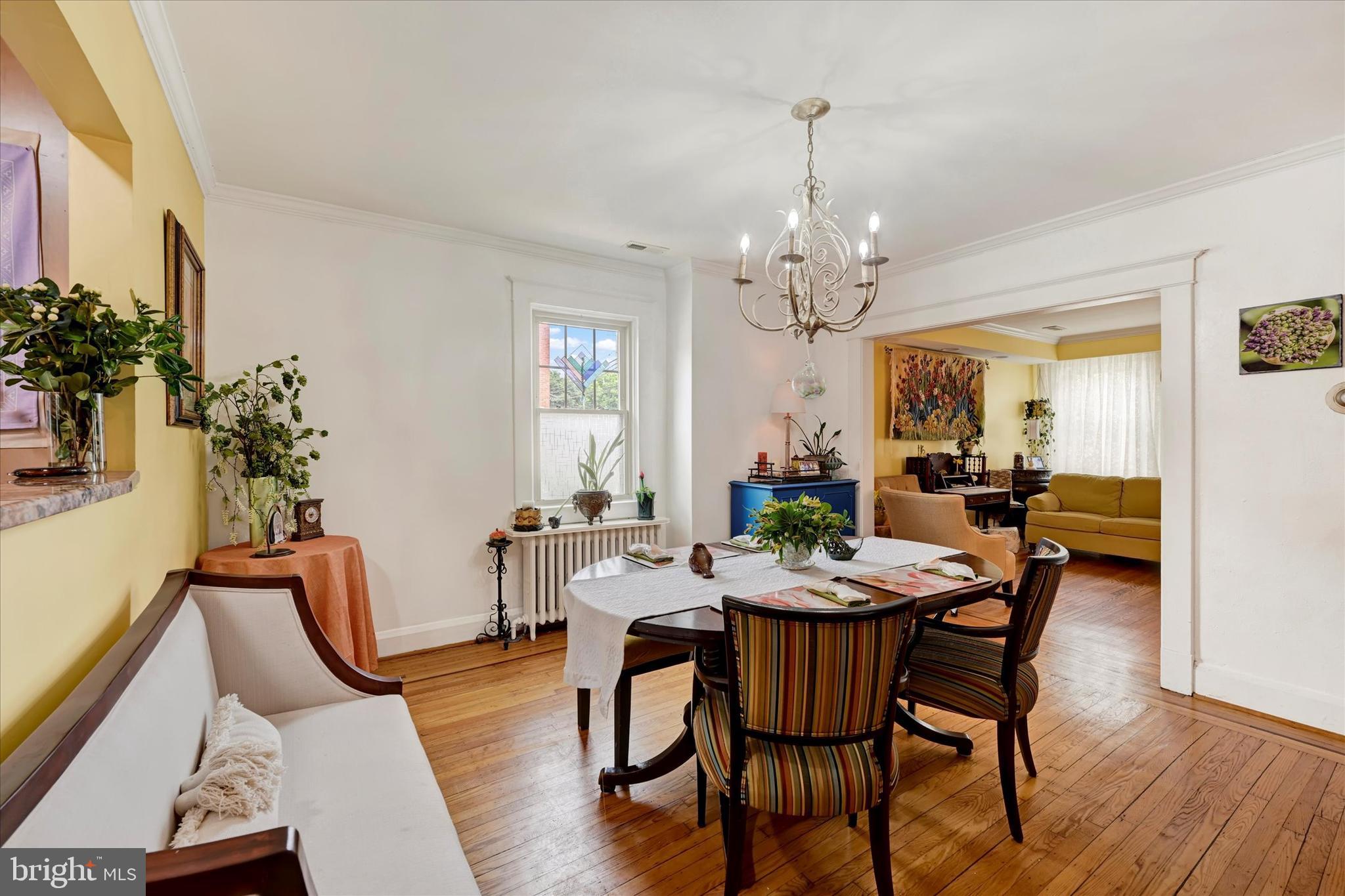 4224 Evans Chapel Road Baltimore, MD 21211 - Photo 6 of 24 a view of a dining room with furniture window and wooden floor