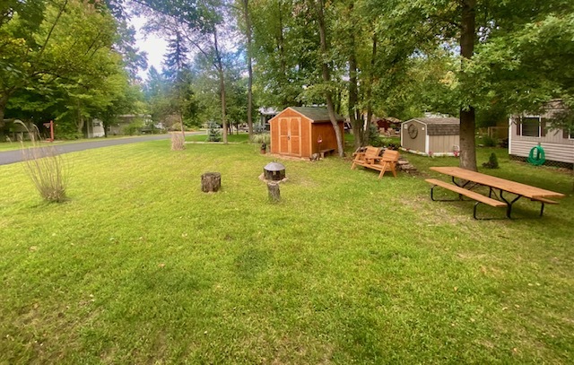 8-90 Woodhaven Sublette, IL 61367 - Photo 8 of 30 a view of a swimming pool with a bench and trees
