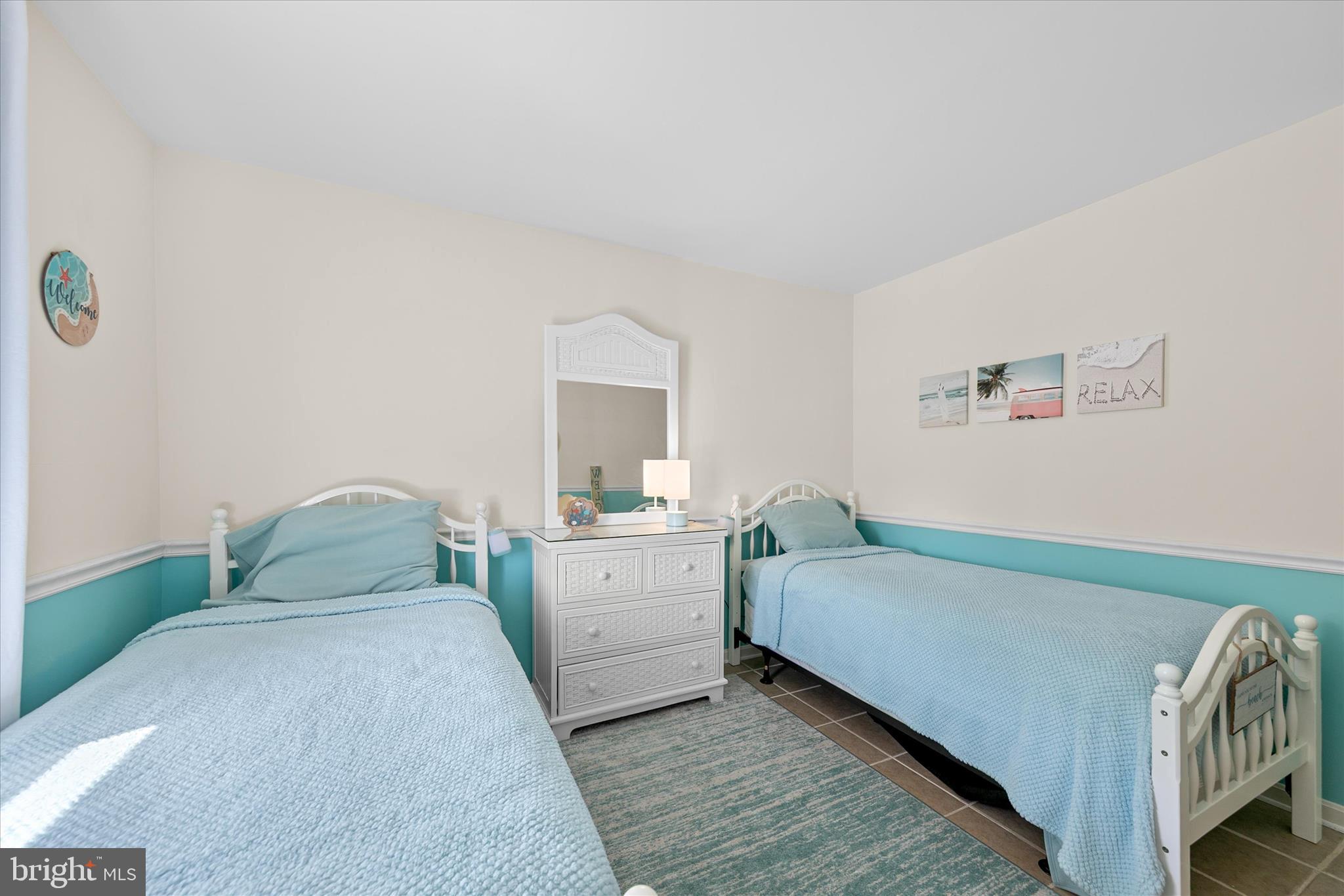 132 Jamestown Road, Unit 601 Ocean City, MD 21842 - Photo 22 of 37 a bedroom with a bed and a table