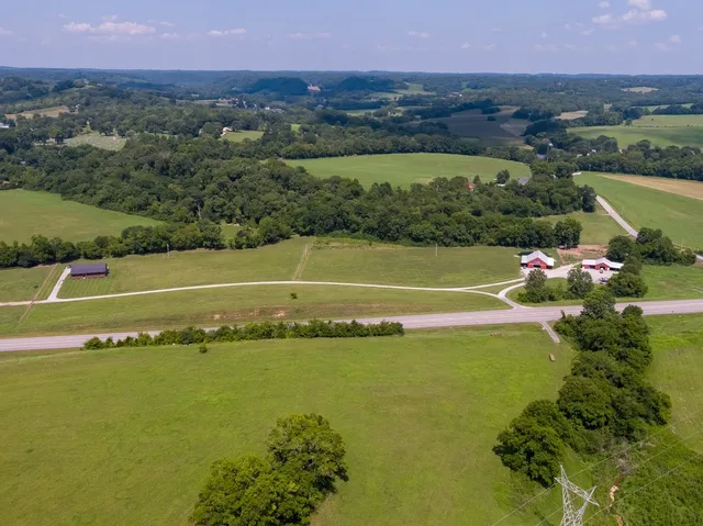 a backyard of a house with a garden and outdoor seating
