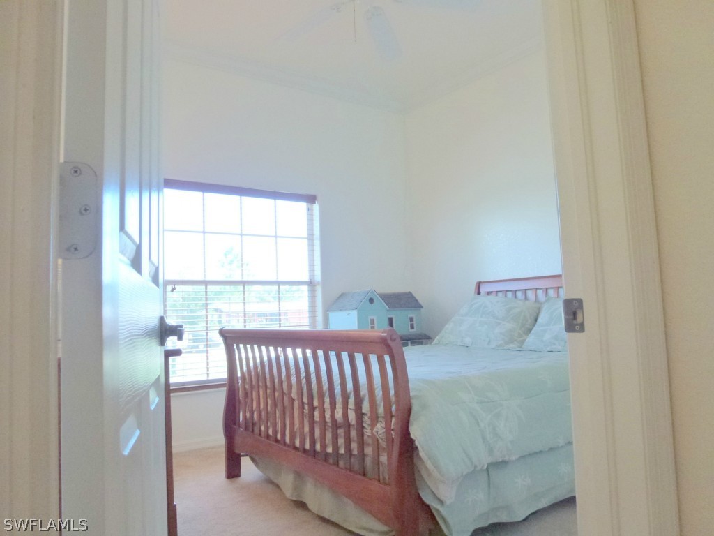 11920 Shawnee Road Fort Myers, FL 33913 - Photo 19 of 25 a bedroom with a bed and a window with outer view