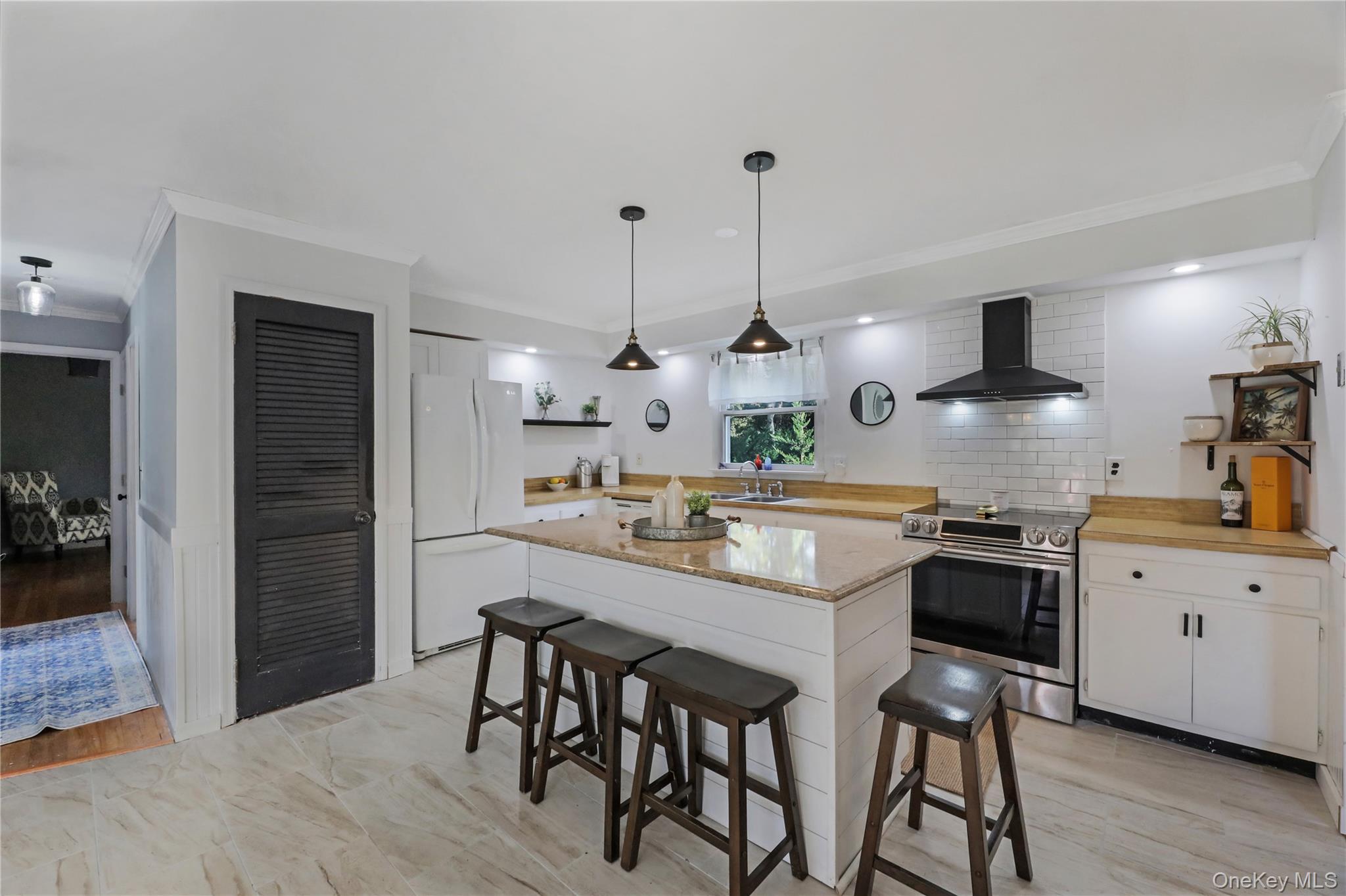 48 Nidzyn Avenue Remsenburg, NY 11960 - Photo 11 of 43 a kitchen with stainless steel appliances kitchen island a chandelier and refrigerator