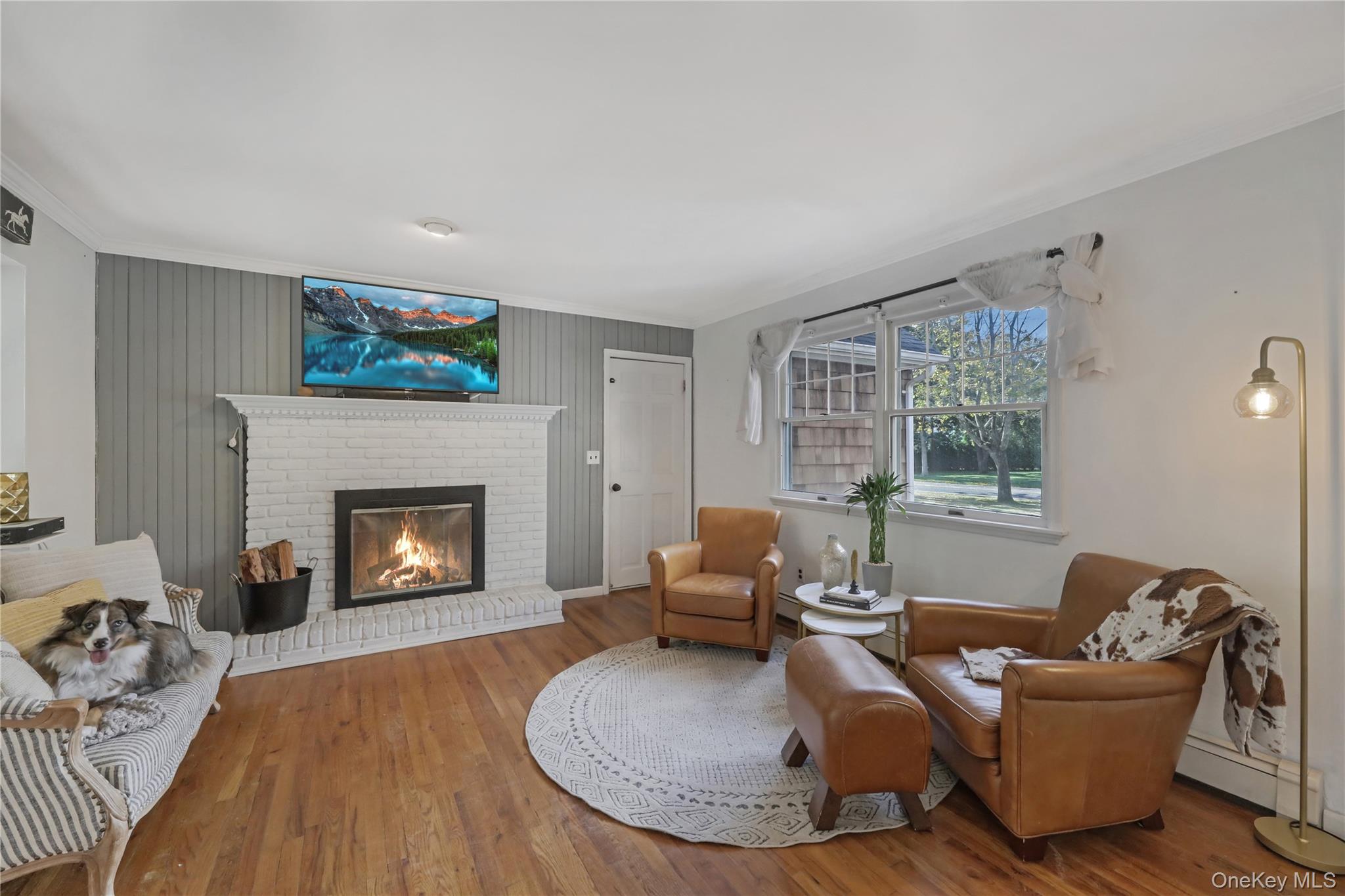 48 Nidzyn Avenue Remsenburg, NY 11960 - Photo 13 of 43 a living room with furniture and a fireplace
