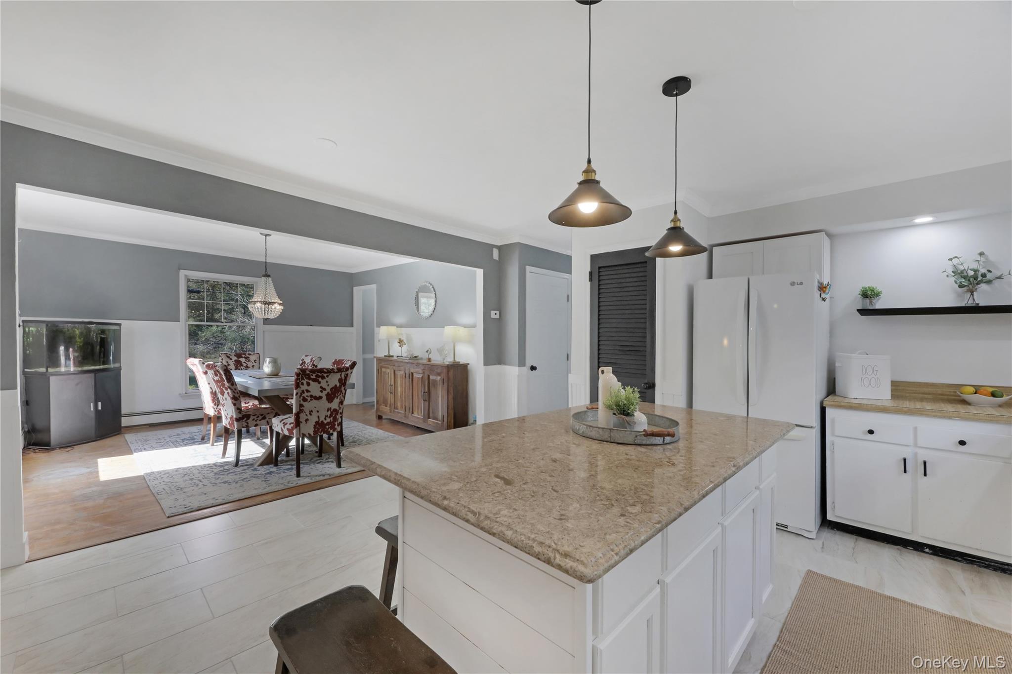 48 Nidzyn Avenue Remsenburg, NY 11960 - Photo 15 of 43 a kitchen with stainless steel appliances granite countertop sink table and chairs