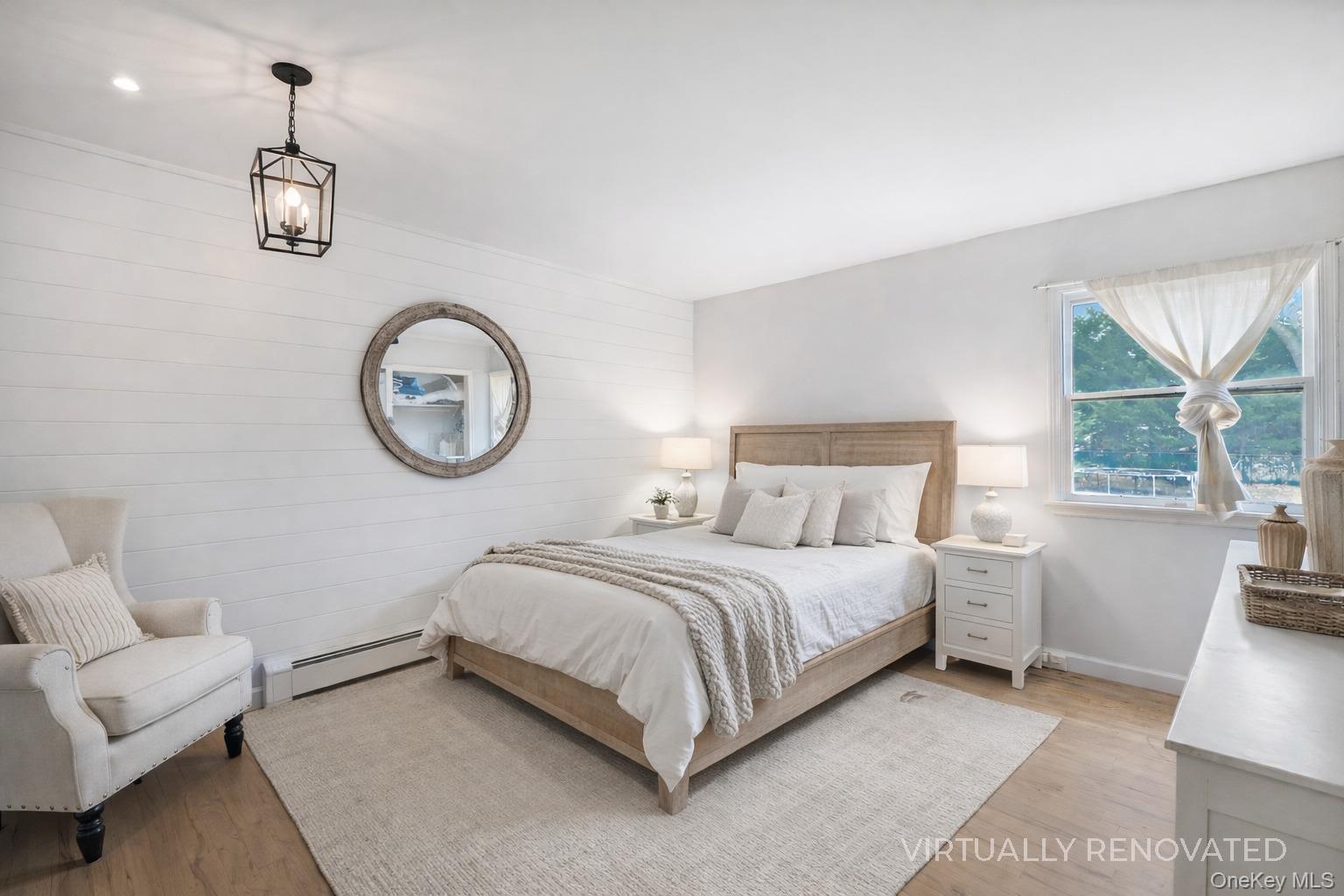 48 Nidzyn Avenue Remsenburg, NY 11960 - Photo 18 of 43 a bed room with a bed mirror and a large window