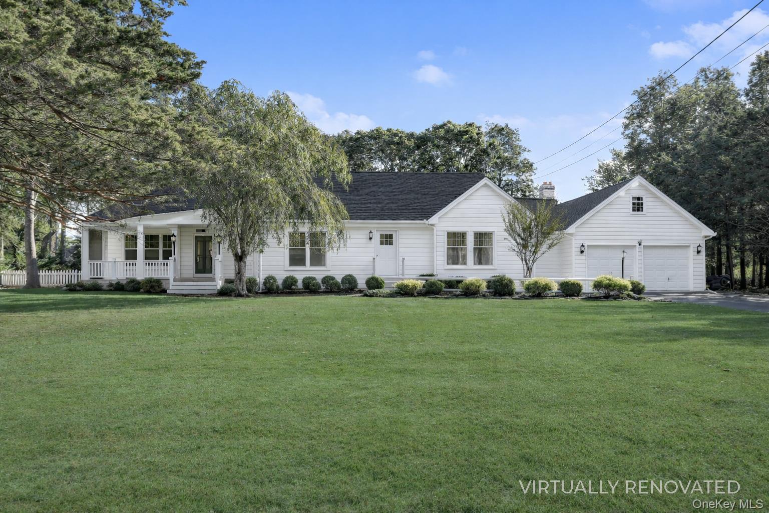 48 Nidzyn Avenue Remsenburg, NY 11960 - Photo 2 of 43 a front view of a house with a garden