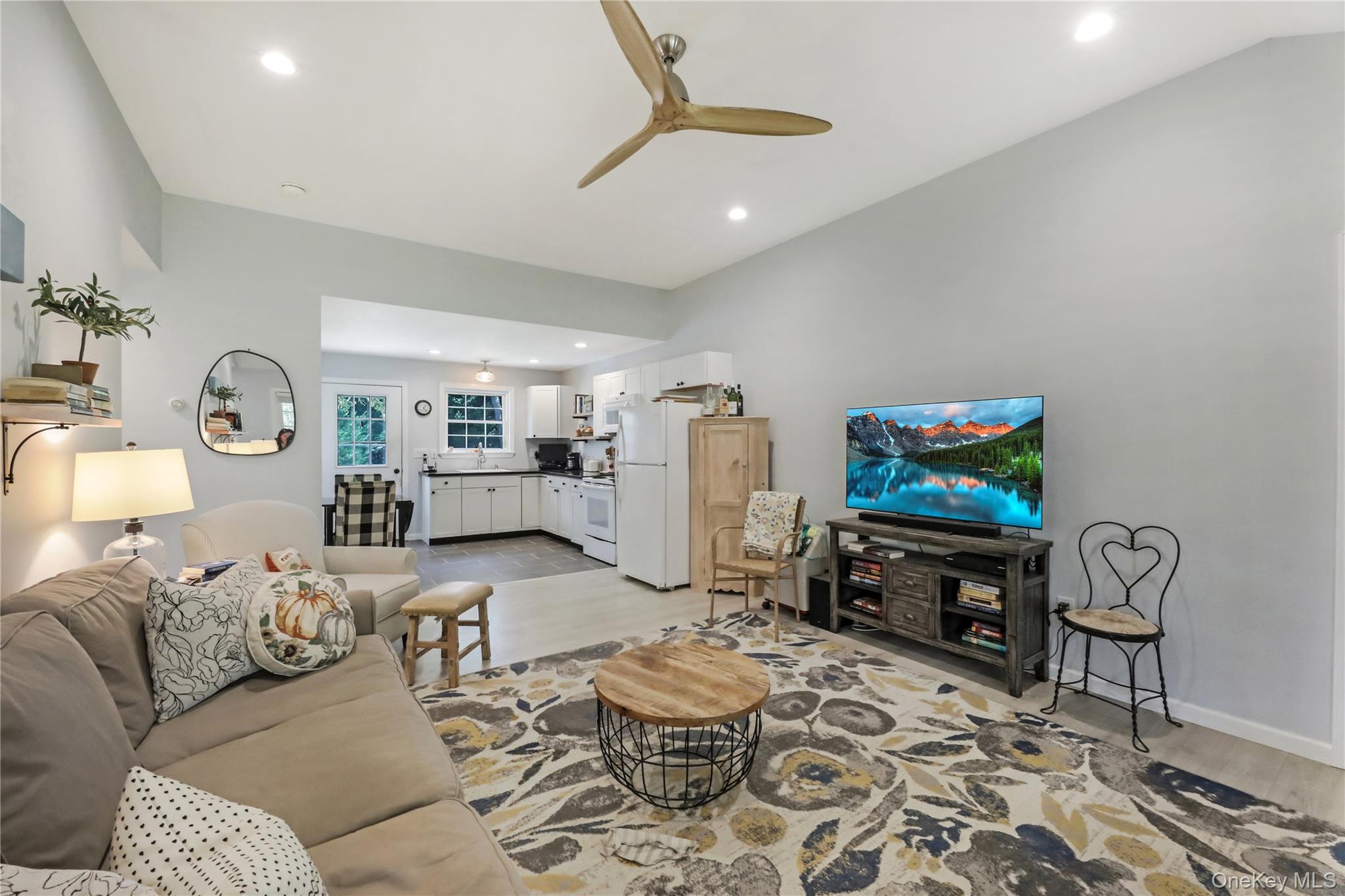 48 Nidzyn Avenue Remsenburg, NY 11960 - Photo 21 of 43 a living room with furniture and a flat screen tv