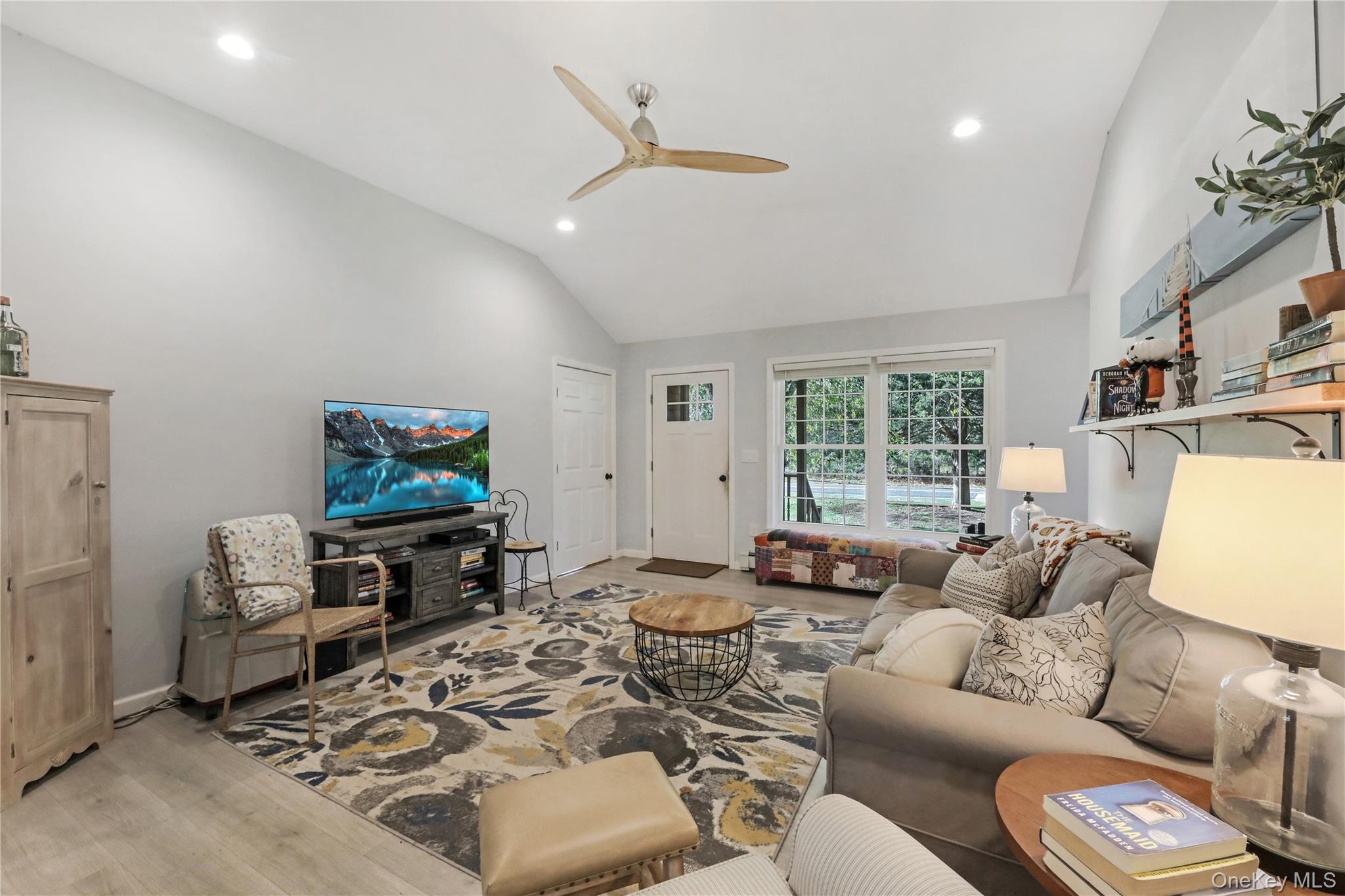 48 Nidzyn Avenue Remsenburg, NY 11960 - Photo 22 of 43 a living room with furniture a flat screen tv and a window