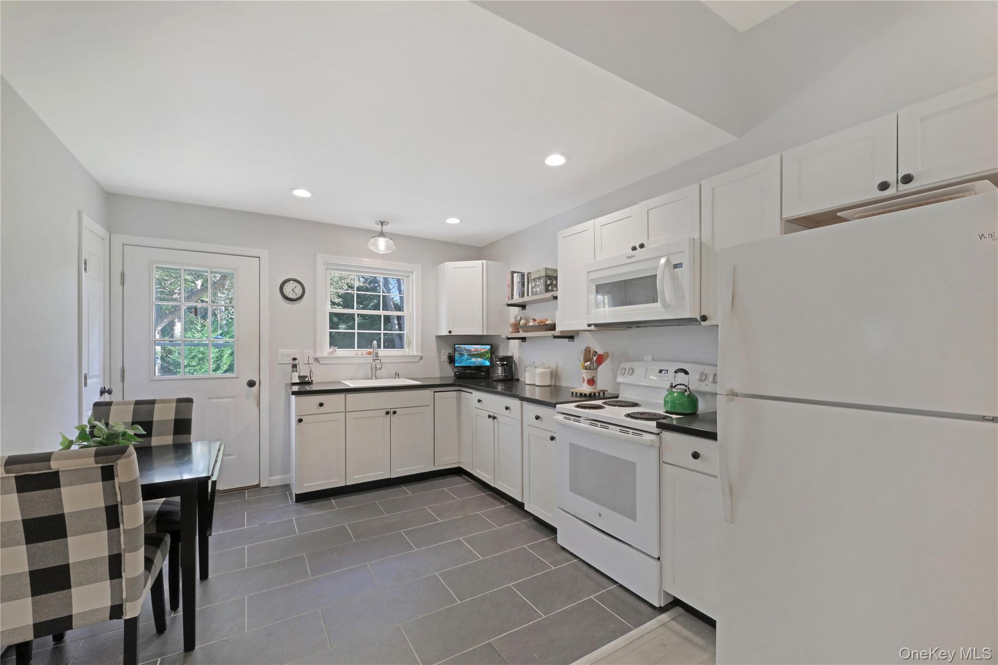 48 Nidzyn Avenue Remsenburg, NY 11960 - Photo 23 of 43 a kitchen with white cabinets and white appliances