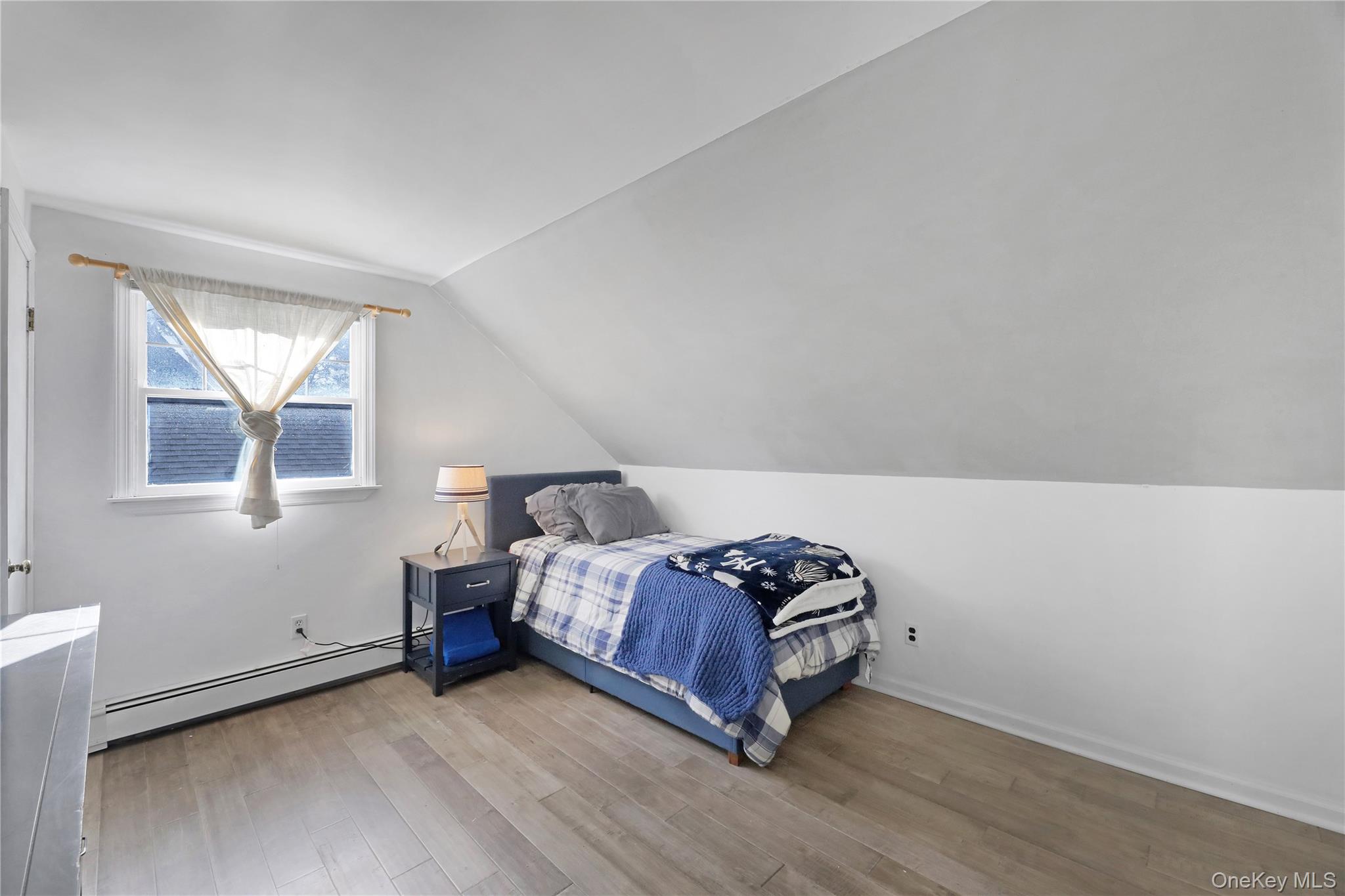 48 Nidzyn Avenue Remsenburg, NY 11960 - Photo 27 of 43 a bedroom with a bed and a window