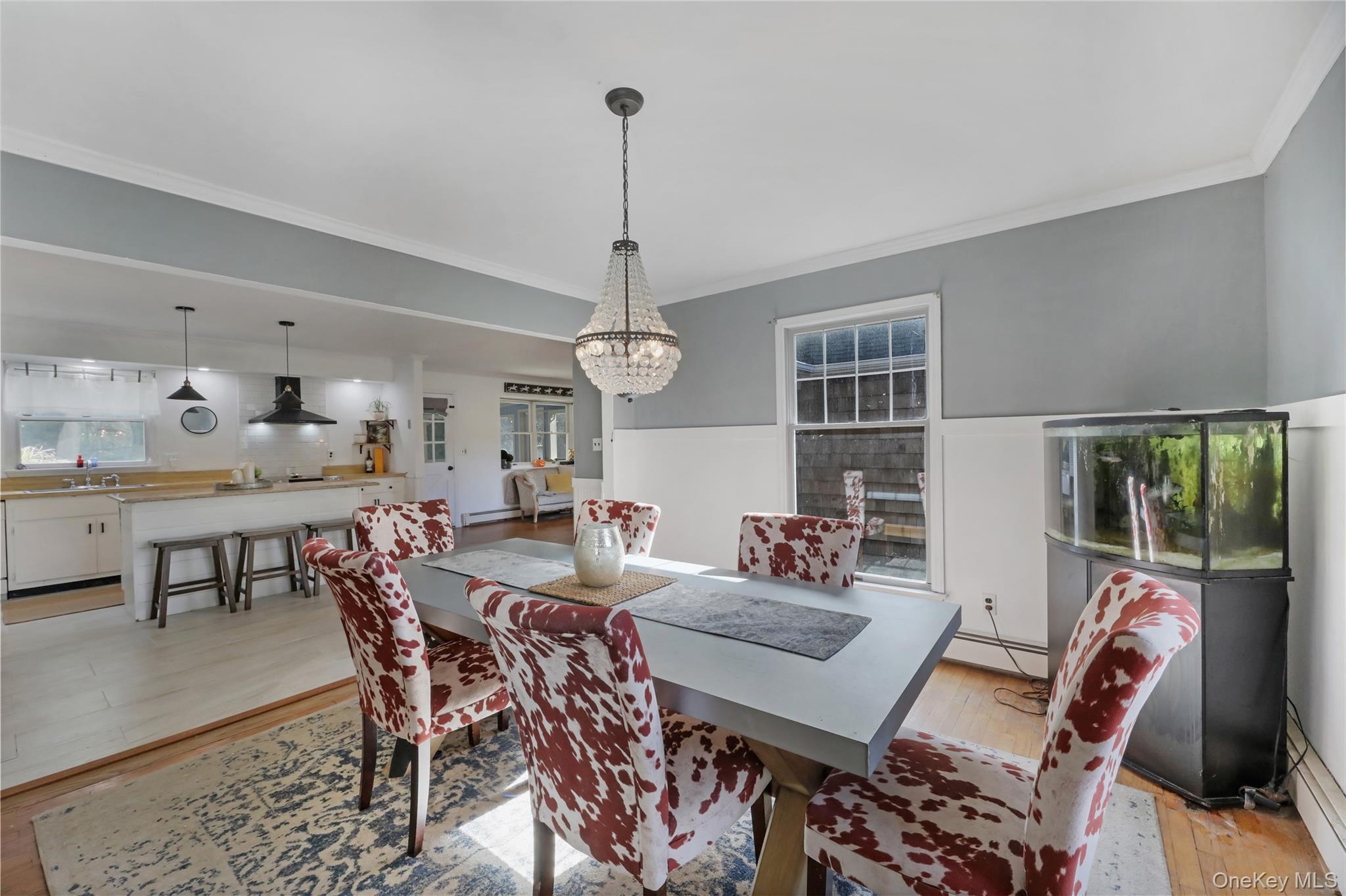48 Nidzyn Avenue Remsenburg, NY 11960 - Photo 7 of 43 a view of a dining room with furniture window and wooden floor