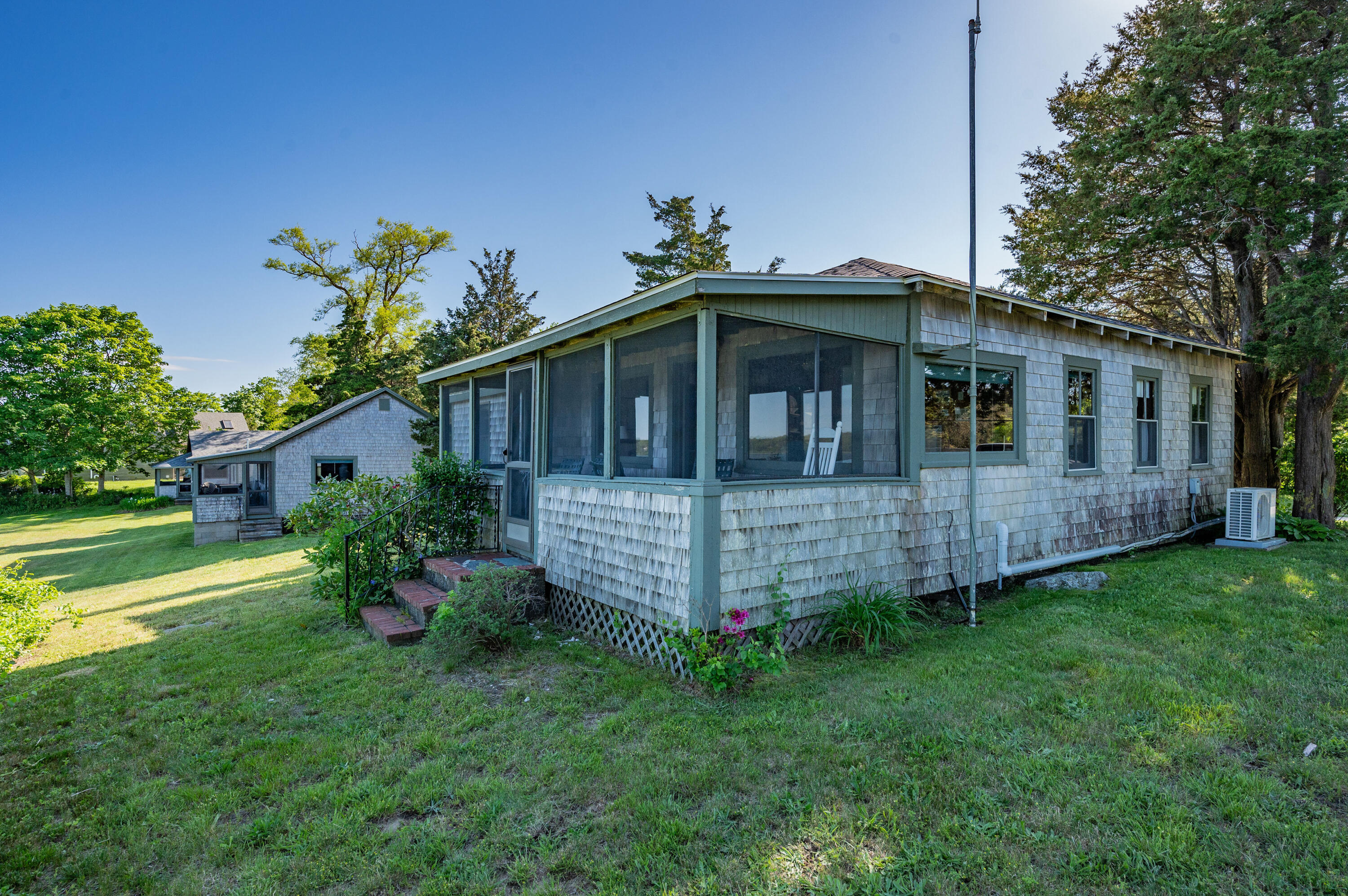150 State Highway Eastham, MA 02642 - Photo 26 of 45 a view of a house with a yard plants and large tree