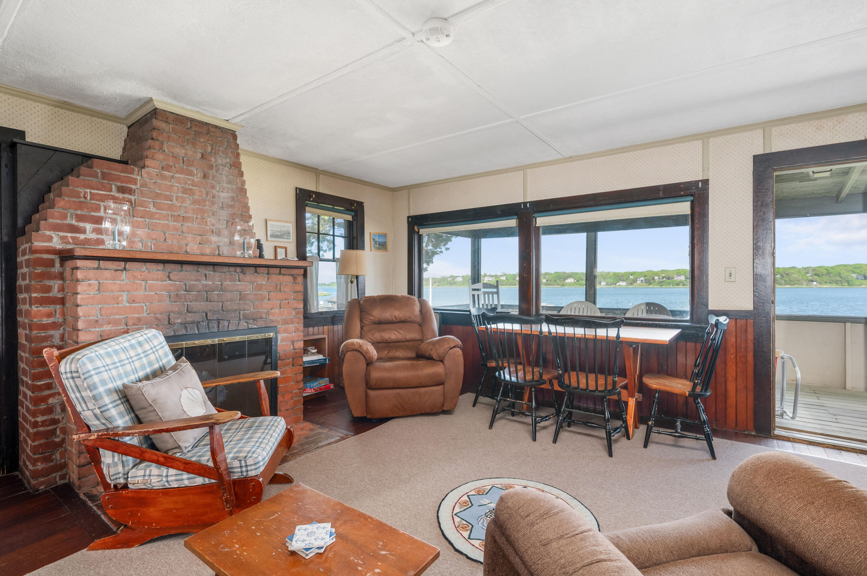 150 State Highway Eastham, MA 02642 - Photo 31 of 45 a living room with furniture a fireplace and floor to ceiling windows