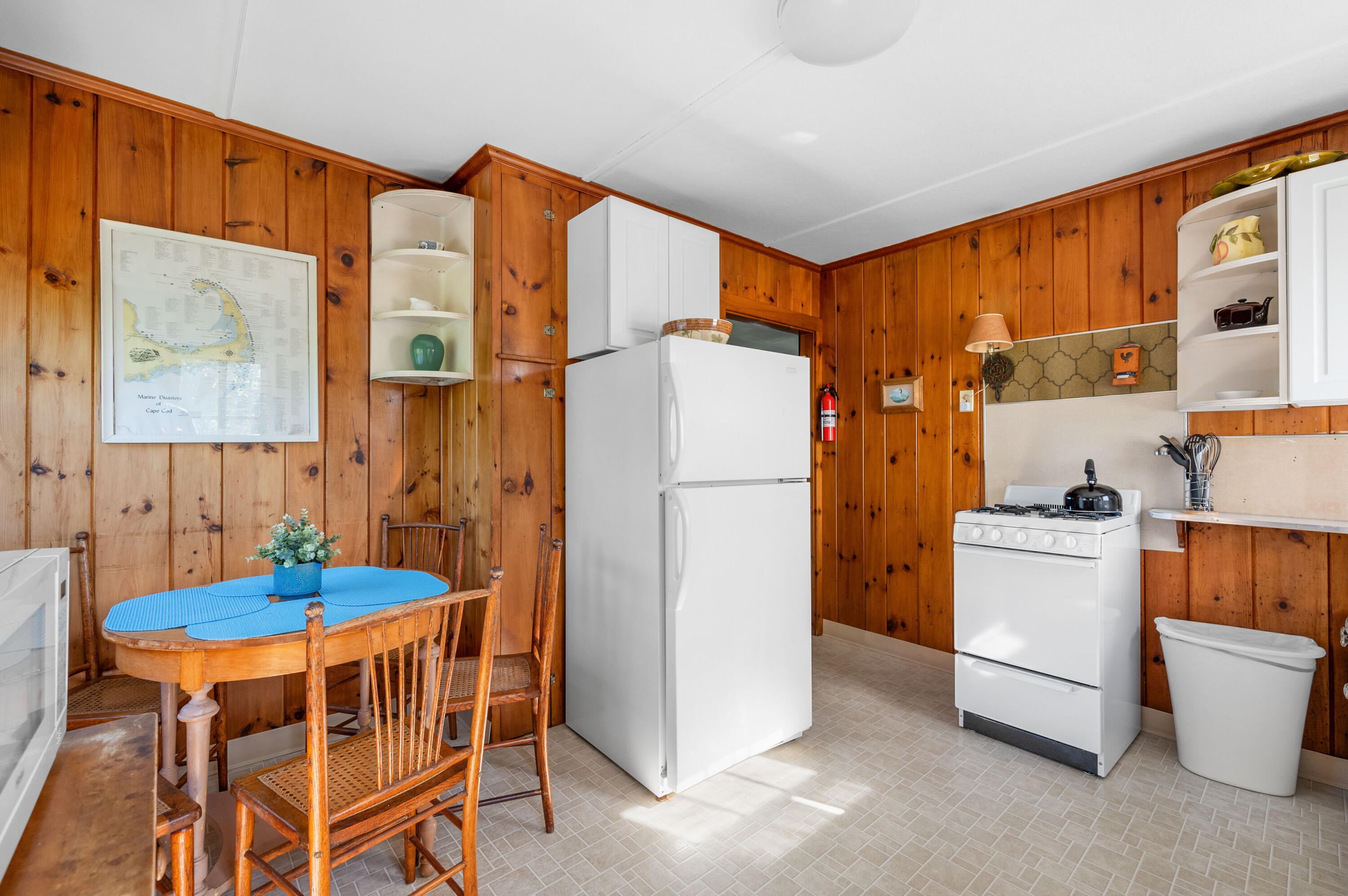 150 State Highway Eastham, MA 02642 - Photo 32 of 45 a kitchen that has a dining table and stainless steel appliances