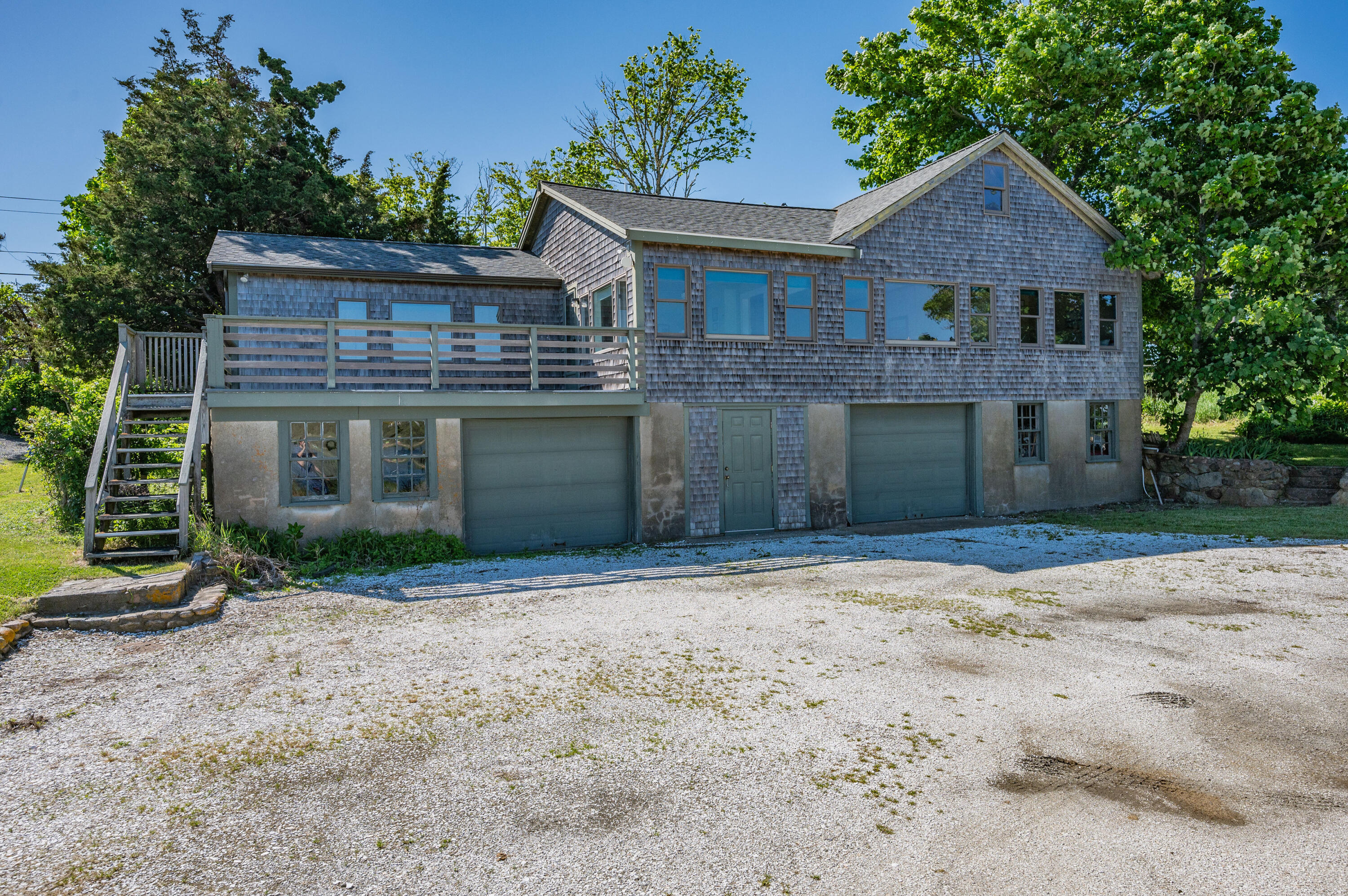 150 State Highway Eastham, MA 02642 - Photo 8 of 45 a front view of a house with a yard and a garage