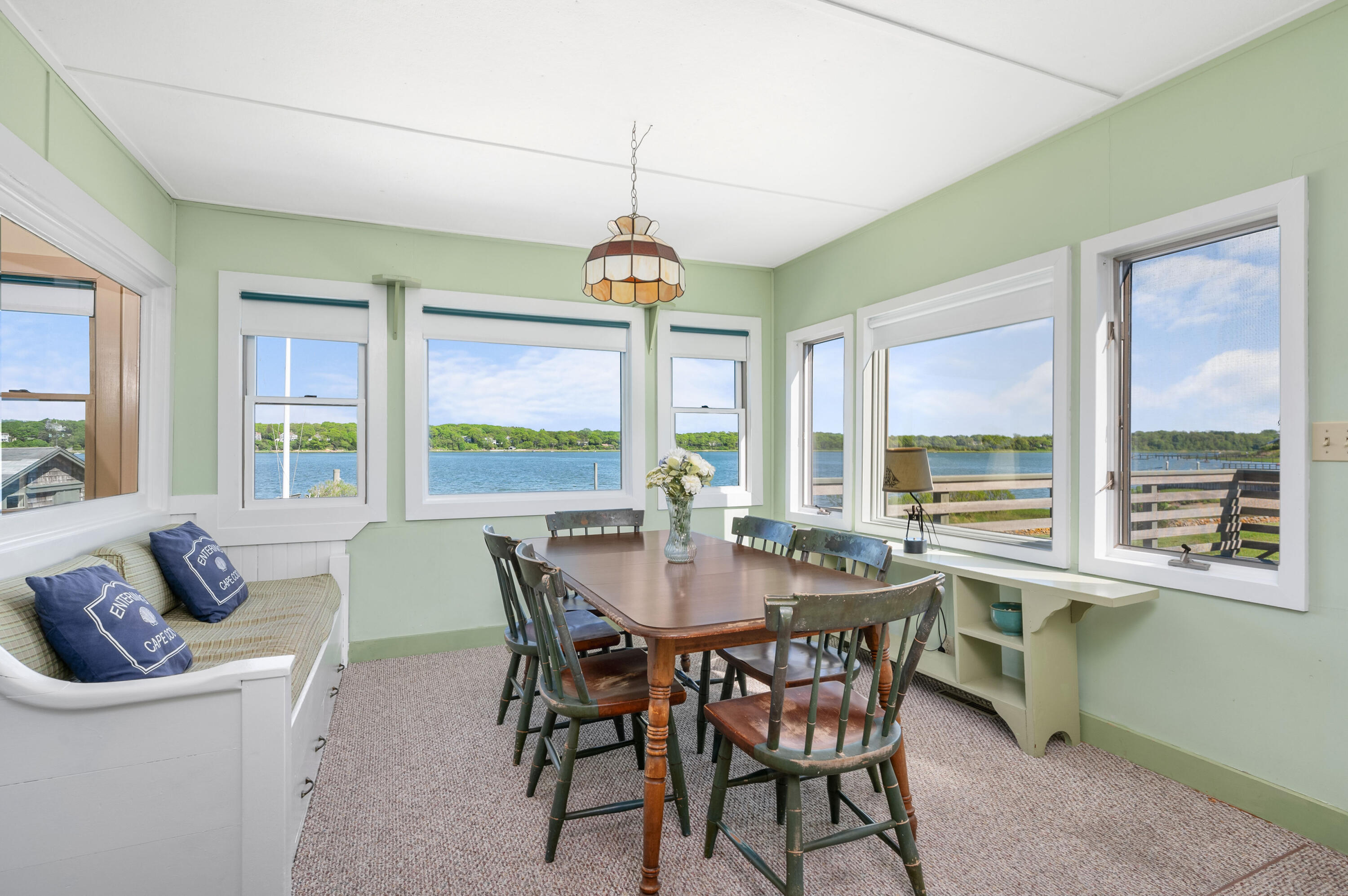 150 State Highway Eastham, MA 02642 - Photo 9 of 45 a view of a dining room with furniture large windows and wooden floor