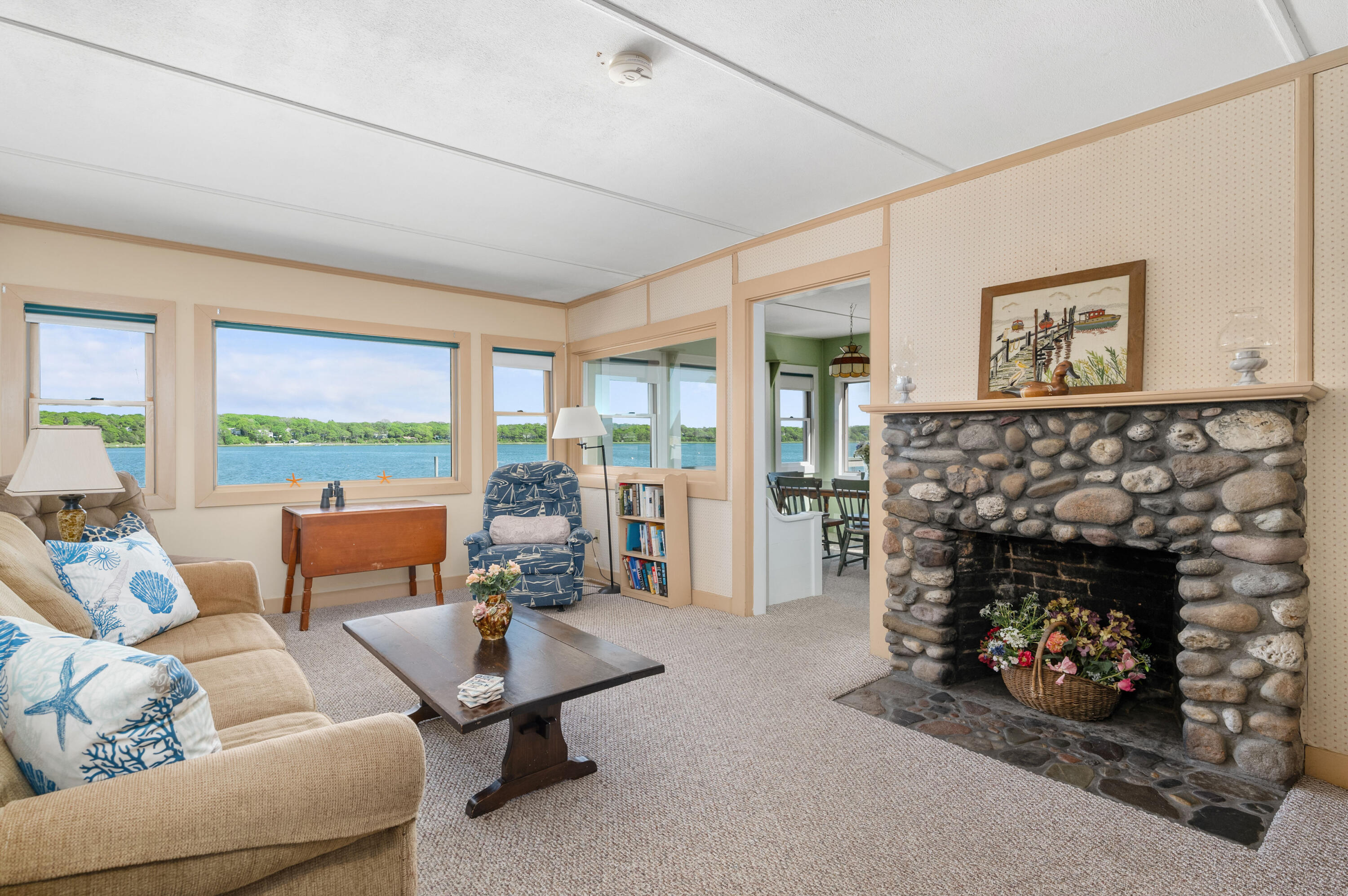 150 State Highway Eastham, MA 02642 - Photo 10 of 45 a living room with furniture a fireplace and a floor to ceiling window