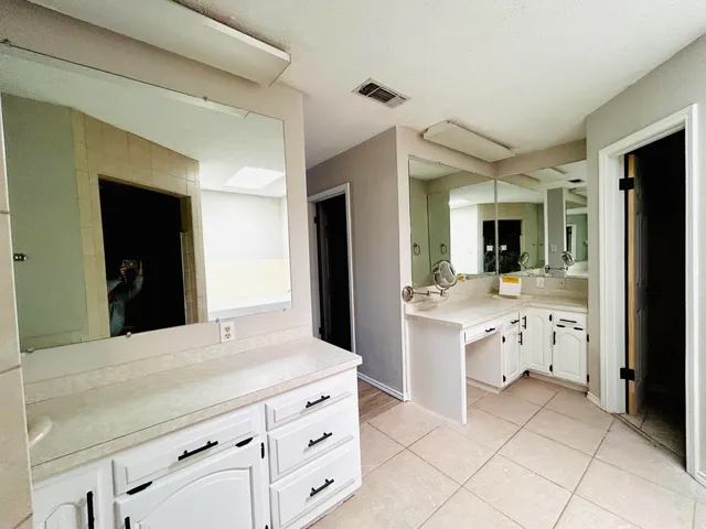 an empty room with a window and a ceiling fan