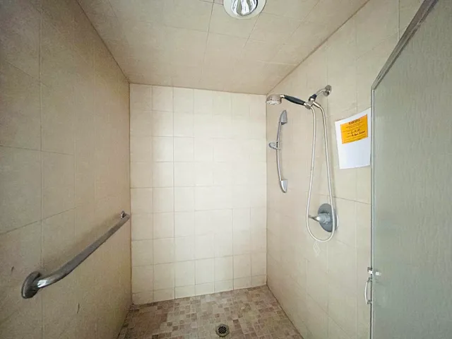 a spacious bathroom with a mirror and a toilet